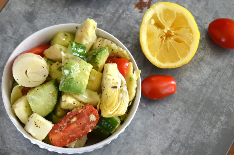 Marinated Artichoke Salad is crazy good combination of avocado, tomatoes, cucumbers, artichoke hearts and hearts of palm in a tangy, garlic dressing.