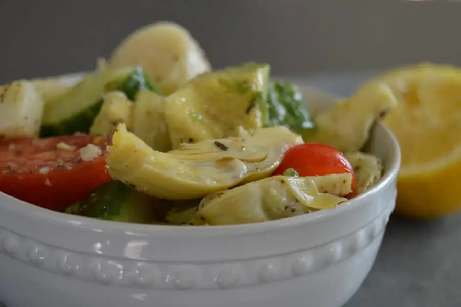 Marinated Artichoke Salad is crazy good combination of avocado, tomatoes, cucumbers, artichoke hearts and hearts of palm in a tangy, garlic dressing.