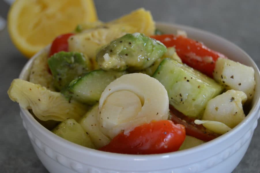 Marinated Artichoke Salad is crazy good combination of avocado, tomatoes, cucumbers, artichoke hearts and hearts of palm in a tangy, garlic dressing.