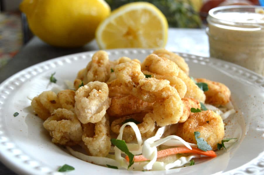 Perfectly crispy, gluten free golden fried calamari with dynamite dipping sauce
