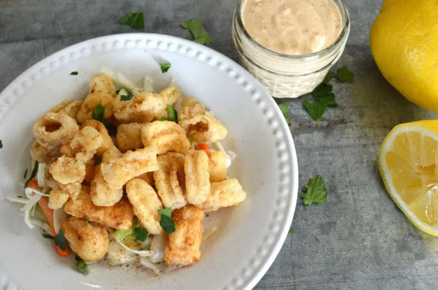 Perfectly crispy, gluten free golden fried calamari with dynamite dipping sauce