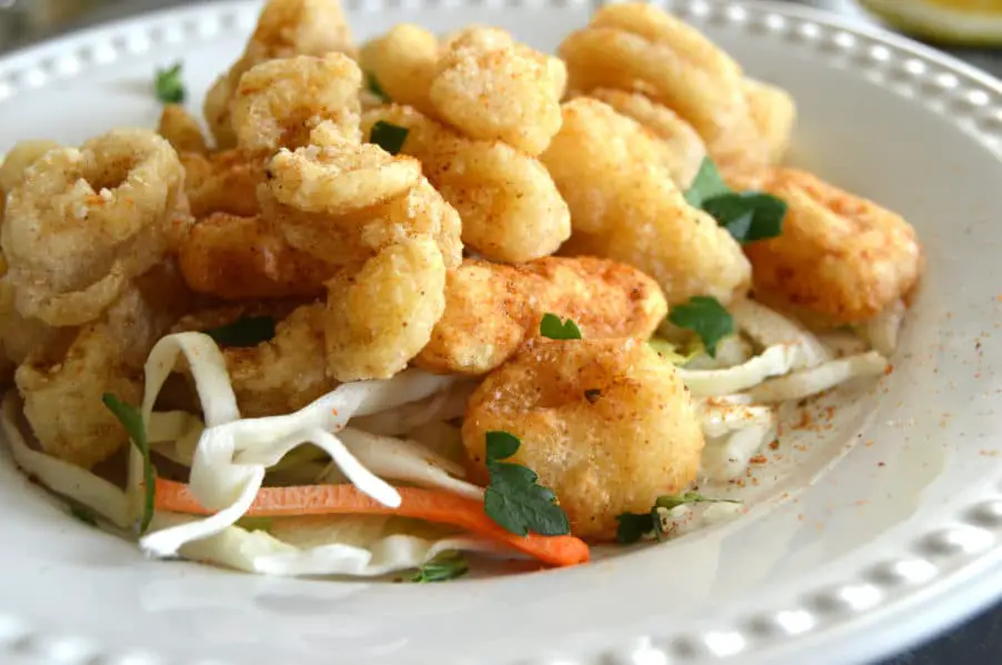 Perfectly crispy, gluten free golden fried calamari with dynamite dipping sauce